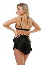 model wears black bralette and black silk satin pyjama shorts