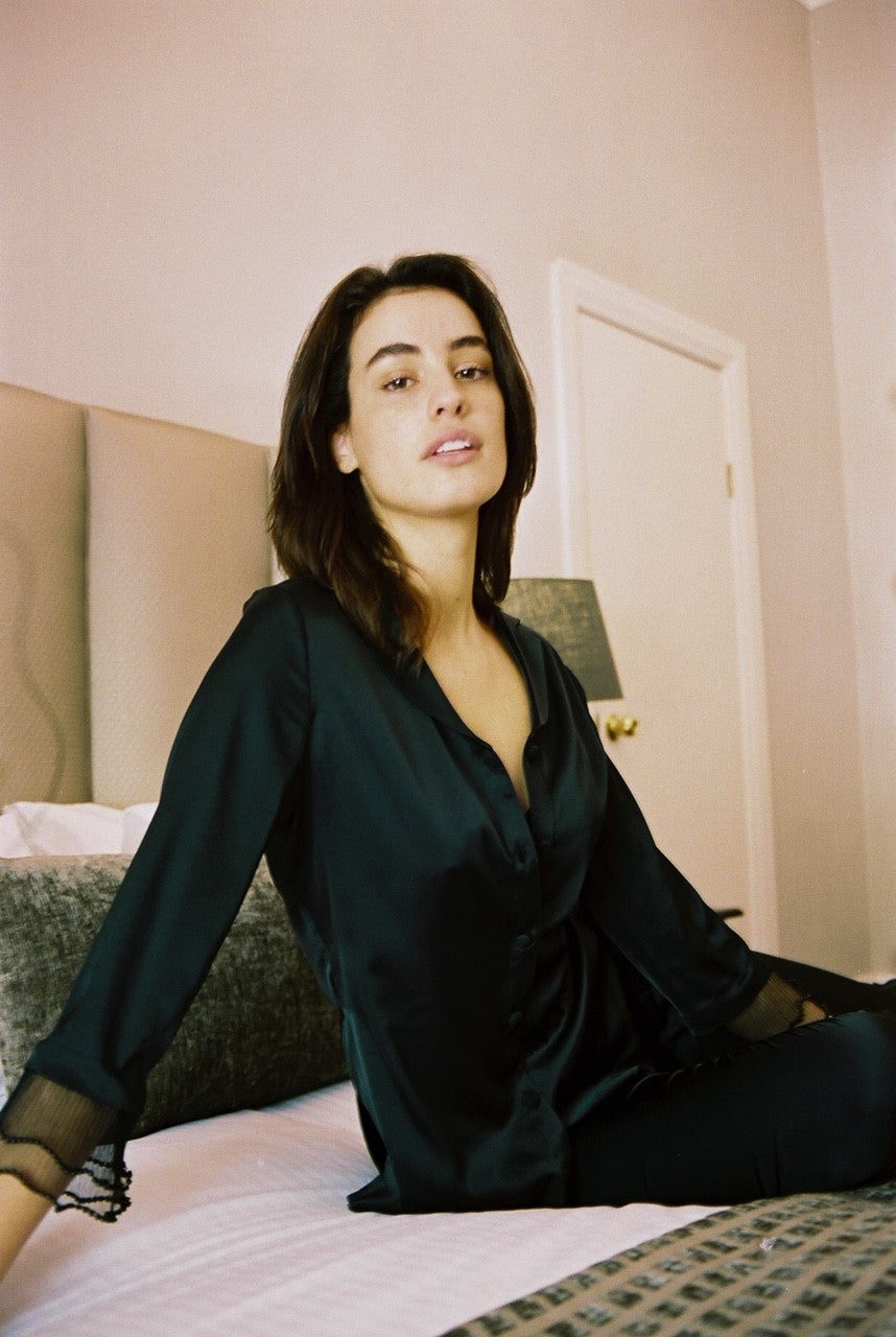 model wears black silk pjyamas