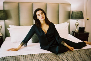 model wears black silk pyjama set